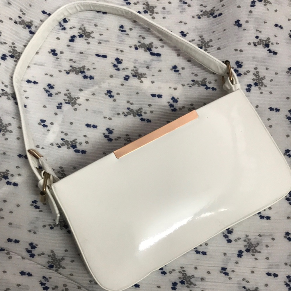 It’s a white colored hand bag of krazy cat
